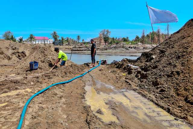 Sejumlah warga membersihkan sisa endapan lumpur di halaman rumah miliknya di Desa Manyang Cut, Kecamatan Meureudu, Kabupaten Pidie Jaya, Aceh, Minggu (8/2/2026). Foto: Akramul Muslim/ANTARA FOTO