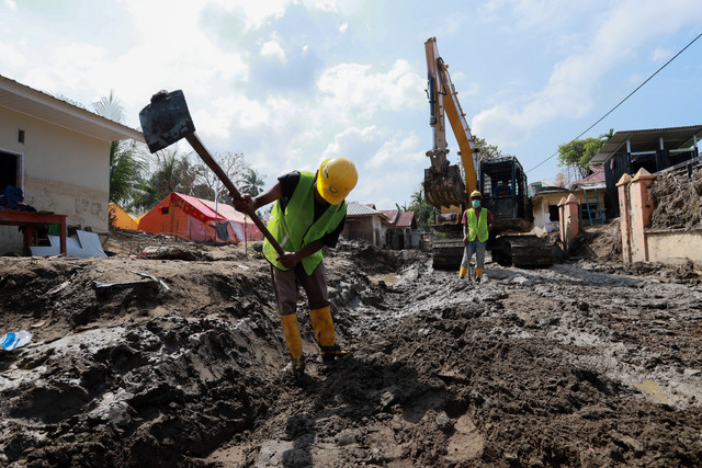 Sejumlah pekerja membersihkan saluran air di permukiman warga Desa Manyang Cut, Kecamatan Meureudu, Kabupaten Pidie Jaya, Aceh, Selasa (10/2/2026). Foto: Akramul Muslim/ANTARA FOTO