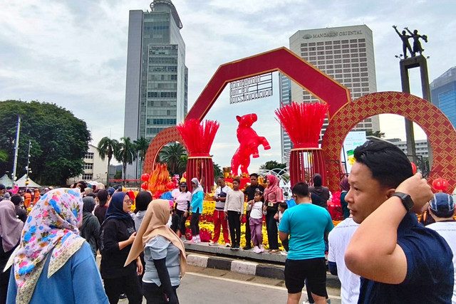 Sejumlah warga tampak berfoto di ornamen Imlek sambil menikmati Car Free Day (CFD) di sekitar kawasan Bundaran HI, Jakarta Pusat, Minggu (15/2/2026). Foto: Jeni Ritanti/kumparan