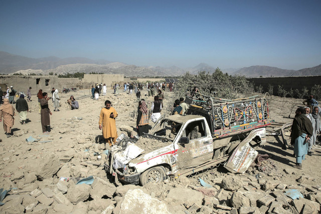 Warga berkumpul di dekat sebuah mobil yang rusak setelah serangan udara Pakistan di daerah pemukiman desa Girdi Kas, distrik Bihsud, provinsi Nangarhar, Afghanistan, Minggu (22/2/2026). Foto: AFP