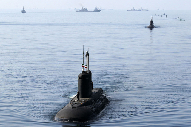 Personel militer Iran memasang bendera nasional di atas kapal selam selama latihan angkatan laut "Velayat-90" di Selat Hormuz di Iran selatan pada 3 Januari 2012. Foto: Ebrahim Nourozi/Jamejam Online/AFP