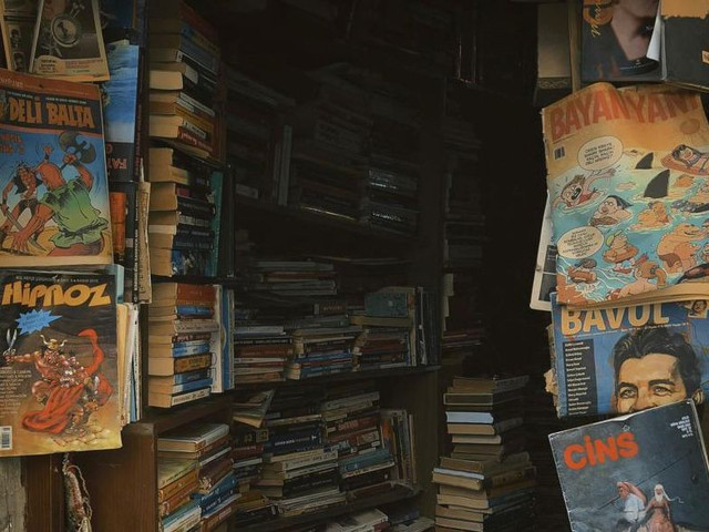 Foto oleh Mehmet Turgut  Kirkgoz : https://www.pexels.com/id-id/foto/toko-buku-vintage-yang-nyaman-dengan-tumpukan-literatur-36162252/