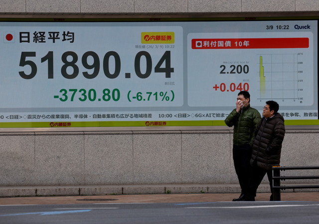 Warga berjalan di dekat papan informasi harga saham yang menampilkan indeks saham Nikkei di luar sebuah perusahaan pialang di Tokyo, Jepang, Senin (9/3/2026). Foto: Kim Kyung-Hoon/REUTERS