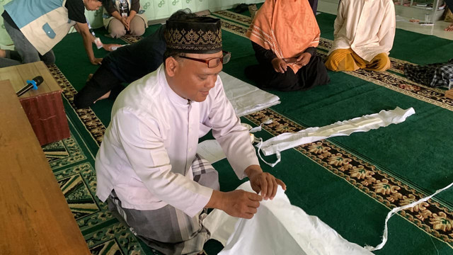 Ustad Budiman selaku pemateri sedang mempraktikkan tata cara memandikan jenazah