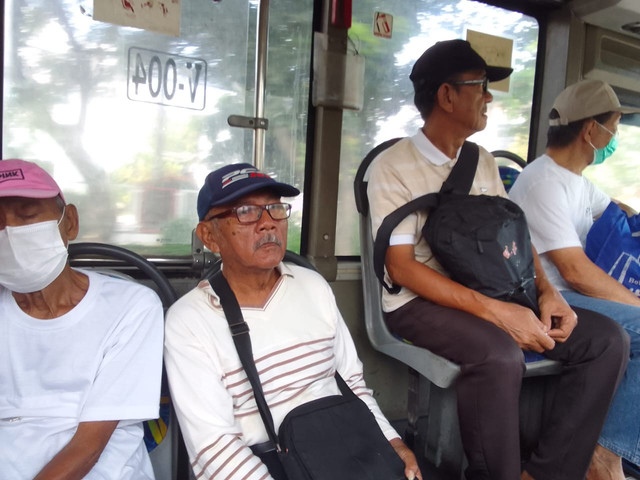 Para lelaki lansia kompak mengenakan topi saat menumpang BRT Trans Semarang Koridor V Rute Meteseh - PRPP, Kamis (2/4/2026) pagi. (Foto: Mohamad Jokomono)