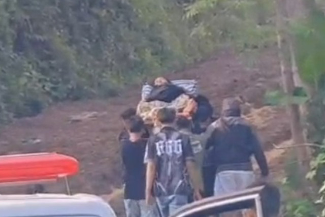 Seorang ibu hamil yang hendak melahirkan harus ditandu setelah mobil ambulan yang membawanya ke rumah sakit tidak mampu melewati jalan rusak berlumpur di Desa Panyindangan, Kecamatan Cibinong, Kabupaten Cianjur, Jawa Barat. Foto: Dok. Istimewa