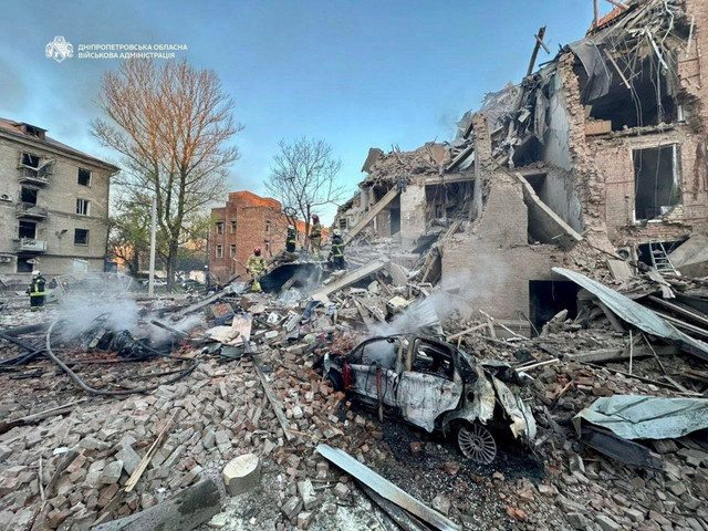 Para penyelamat bekerja di lokasi gedung apartemen yang terkena serangan rudal dan drone Rusia, di tengah serangan Rusia terhadap Ukraina, di Dnipro, Ukraina, Sabtu (25/4/2026). Foto: Alina Smutko/REUTERS