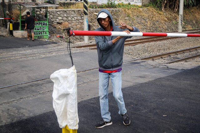 Pengendara melintas di perlintasan sebidang di kawasan Duren Jaya, Kota Bekasi, Kamis (30/4/2026), setelah PT KAI memasang palang pintu pembatas di lokasi tersebut. Foto: Iqbal Firdaus/kumparan