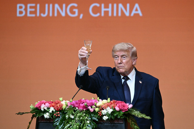 Presiden AS Donald Trump bersulang saat menghadiri jamuan makan malam kenegaraan bersama Presiden Tiongkok Xi Jinping di Balai Besar Rakyat di Beijing, Kamis (14/5/2026). Foto: Brendan Smialowski/AFP