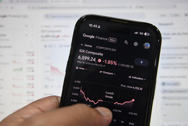 Warga mengamati grafik pergerakan Indeks Harga Saham Gabungan (IHSG) melalui ponsel pintar di Jakarta, Senin (18/5/2026). Foto: M Risyal Hidayat/ANTARA FOTO