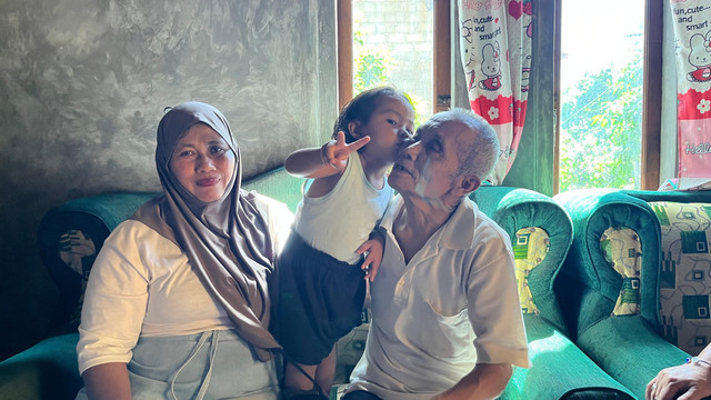 Kakek Mujiran bersama cucunya di Lampung Selatan. Foto: Dok. Istimewa