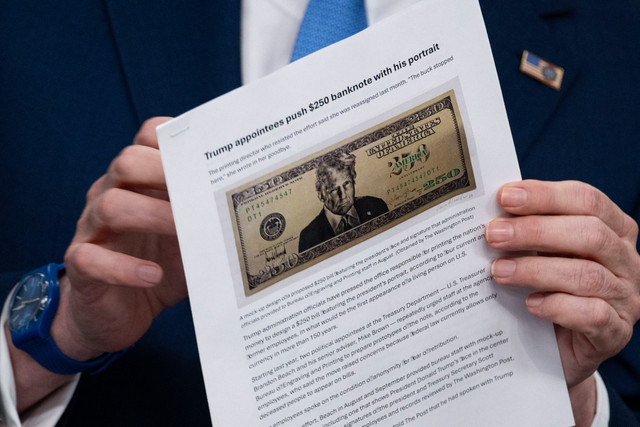 Menteri Keuangan AS Scott Bessent mengangkat artikel Washington Post tentang usulan uang kertas 250 dolar dengan potret Presiden AS Donald Trump saat konferensi pers di Gedung Putih di Washington, D.C., AS, Kamis (28/5/2026). Foto: Kent Nishimura / AFP