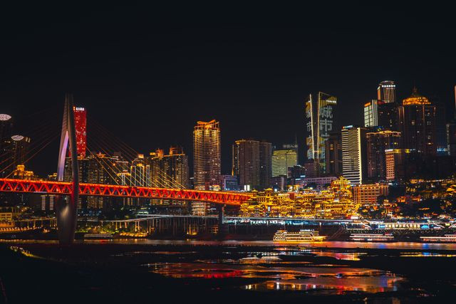 Sumber : Photo by Liuuu _61 from Pexels: https://www.pexels.com/photo/colorful-night-skyline-of-chongqing-with-bridge-32599840/