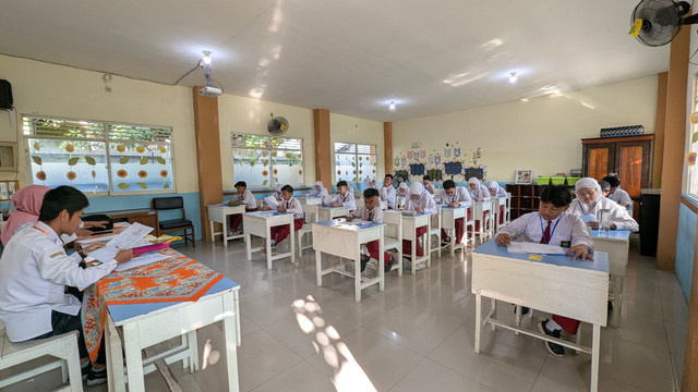 Students in an Indonesian classroom taking an exam under natural lighting. Photo by Haidar Azmi from Pexels: https://www.pexels.com/photo/indonesian-students-in-classroom-exam-setting-31940733/