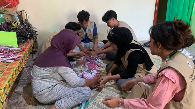 Mahasiswa UM BBM Universitas Negeri Malang belajar proses pembuatan tas anyaman plastik bersama pengrajin lokal di Desa Baleasri sebagai bentuk pendampingan dan pemberdayaan UMKM desa.