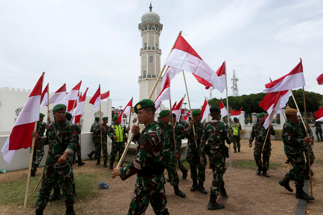 Prajurit TNI menyiapkan bendera Merah Putih untuk dikibarkan kembali di halaman Masjid Raya Baiturrahman, Banda Aceh, Aceh, Minggu (16/8/2026). Foto: Irwansyah Putra/ANTARA FOTO