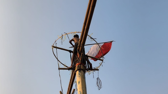 Momen Pemenang Lomba Panjat Gedebok Pisang Mengibarkan Bendera Merah Putih di Puncak Gedebok Pisang pada Peringatan HUT ke-81 RI di RT. 004/02, Pulogebang, Cakung, Jakarta Timur, Senin (17/8/2026). Foto: Aditya Nugraha/kumparan