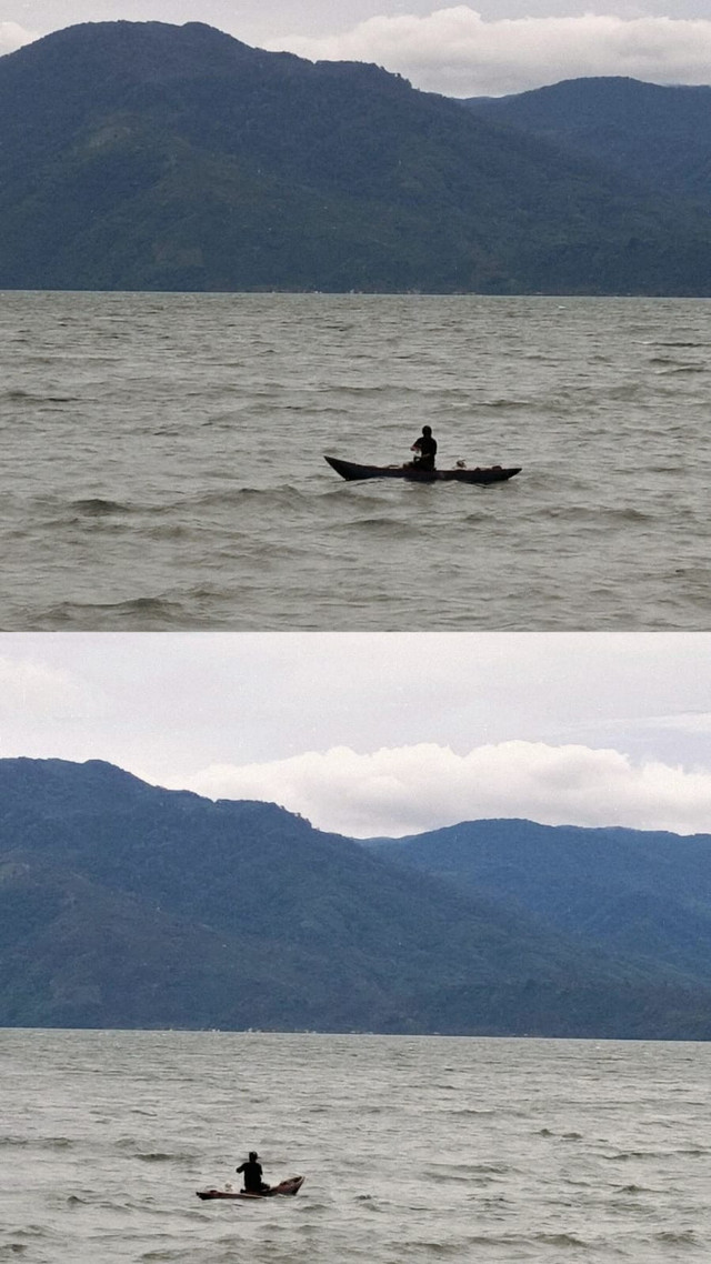 Pemandangan Danau Ranau dengan seorang pengendara perahu di tengah danau dan latar pegunungan saat saya berkunjung ke Sumatera Selatan. (Dok. pribadi)