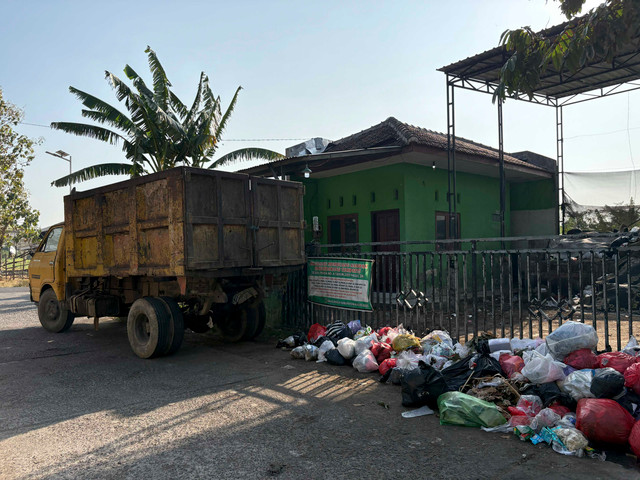 Truk sampah milik Dinas PKPLH Kudus yang tak terlihat nopolnya sedang mengambil sampah di TPS Desa Panjang pada Selasa (22/9/2026). Foto: Vega Maarijil Ula/kumparan