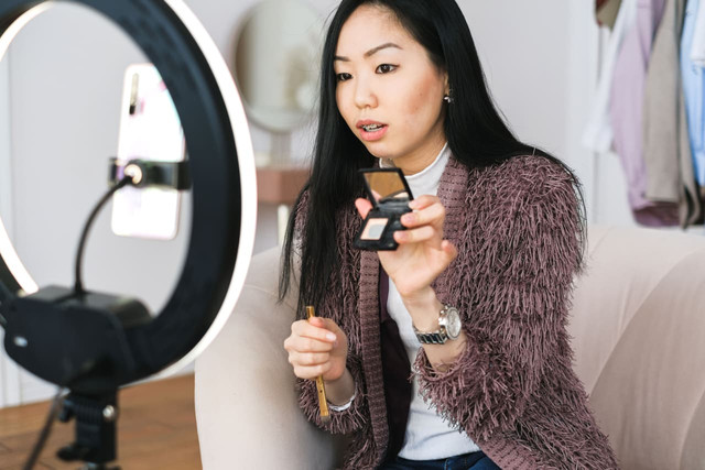 Photo by Anna Shvets from Pexels: https://www.pexels.com/photo/woman-vlogging-about-makeup-6593783/