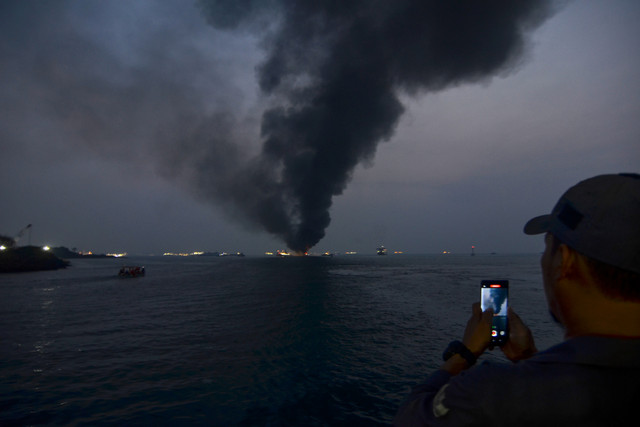 Warga memotret Kapal Motor Penumpang (KMP) Batumandi yang terbakar di perairan Pelabuhan Merak, Kota Cilegon, Banten, Selasa (20/10/2026). Foto: Rikardo/ANTARA FOTO