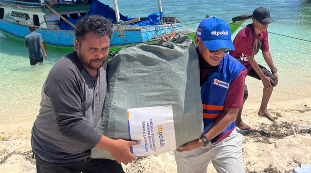 Relawan DT Peduli dan Warga Saling Bantu Mengangkut Bantuan Logistik yang dikirim menggunakan Kapal (Sumber: DT Peduli)