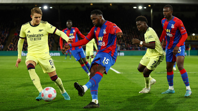 Pemain Crystal Palace Jeffrey Schlupp berebut bola dengan pemain Arsenal Martin Odegaard pada pertandingan lanjutan Liga Inggris di Selhurst Park, London, Inggris. Foto: David Klein/REUTERS
