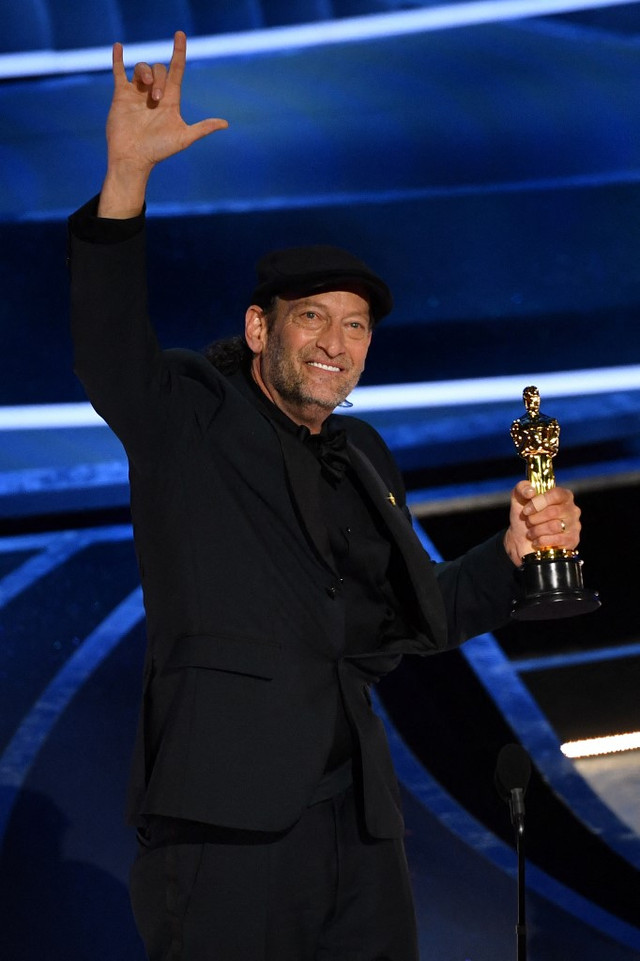 Aktor AS Troy Kotsur menerima penghargaan untuk Aktor Terbaik dalam Peran Pendukung untuk "CODA" saat nominasi Oscar ke-94 di Dolby Theatre di Hollywood, California, Amerika Serikat. Foto: Robyn Beck/AFP