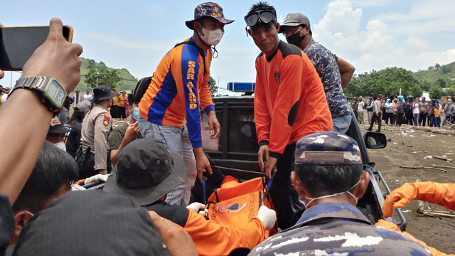 Tim SAR gabungan membawa korban terseret arus di Pantai Payangan, Desa Sumberejo, Ambulu, Jember, Jawa Timur, Minggu (13/2/2022). Foto: Wahyu/Aantara Foto