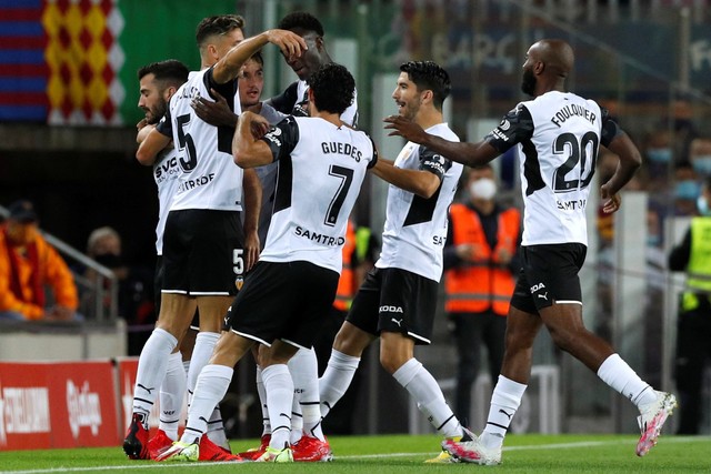 Selebrasi pemain Valencia usai mencetak gol ke gawang FC Barcelona pada pertandingan lanjutan Liga Spanyol di Camp Nou, Barcelona, Spanyol. Foto: Albert Gea/REUTERS