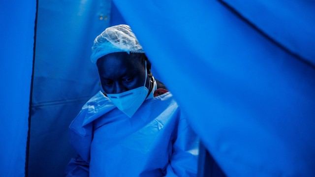 Seorang warga Afrika Selatan mengenakan masker pada sebuah bilik. Foto: Francois Guillot/AFP