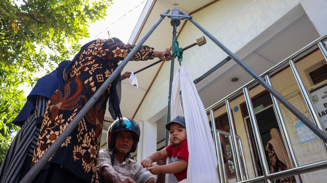 Petugas kesehatan di Banda Aceh menimbang berat badan balita di posyandu sebagai upaya pencegahan stunting pada anak, Jumat (10/12/2021). Foto: Suparta/acehkini