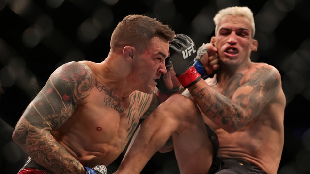 Pertandingan UFC 269 antara Charles Oliveira (kanan) dari Brasil bergulat dengan Dustin Poirier di T-Mobile Arena, Las Vegas, Nevada pada Sabtu (11/12). Foto: Carmen Mandato/Getty Images