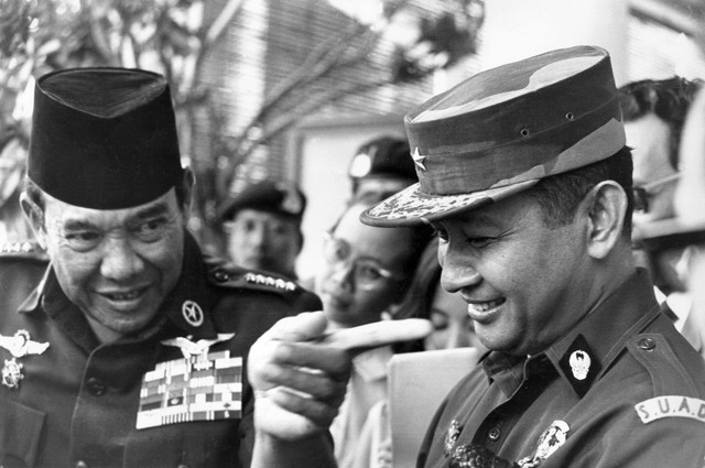 Presiden Indonesia Sukarno (kiri) sedang berbicara dengan Jenderal Suharto setelah sesi pembubaran komando Malaysia, 24 Agustus 1966, di Jakarta. Foto: PANASIA-FILES / AFP