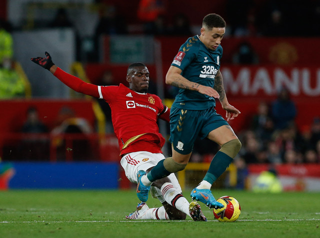 Pemain Manchester United Paul Pogba beraksi dengan pemain Middlesbrough Marcus Tavernier di Old Trafford, Manchester, Inggris - 4 Februari 2022. Foto: Craig Brough/REUTERS