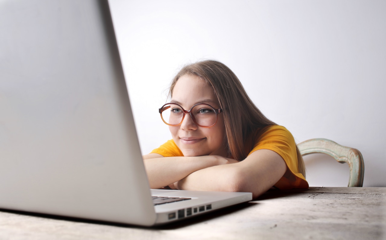 photo-of-smiling-woman-in-a-yellow-shirt-watching-her-laptop-3769020.jpg