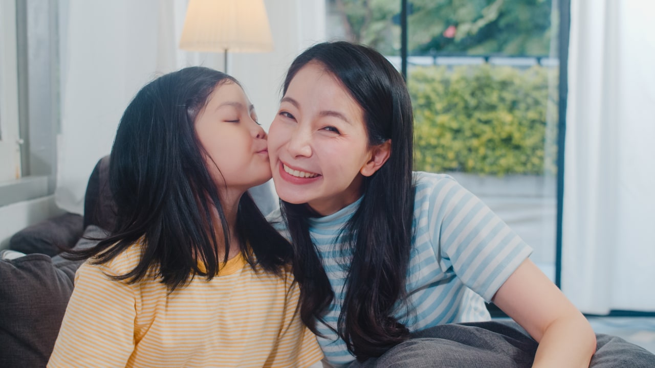 happy-young-asian-family-mom-kid-play-together-couch-home-child-daughter-kiss-her-mom-enjoying-happy-relax-spending-time-together-modern-living-room-evening (1).jpg