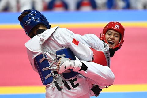 Atlet Taekwondo Indonesia Silvana Lamanda melancarkan tendangan ke arah atlet Taekwondo Vietnam Thi Khiem Bac pada final Taekwondo kategori Kyorugi kelas under 67 kg SEA Games 2021 Vietnam di Tay Ho Gymnasium, Hanoi, Vietnam, Selasa (17/5/2022).  Foto: Zabur Karuru/ANTARA FOTO