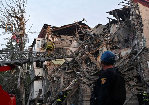 Tim penyelamat berusaha menyelamatkan korban dari bangunan yang rusak berat akibat serangan rudal Rusia, di tengah serangan Rusia ke Ukraina, di Zaporizhzhia, Ukraina 6 Oktober 2022. Foto: Reuters