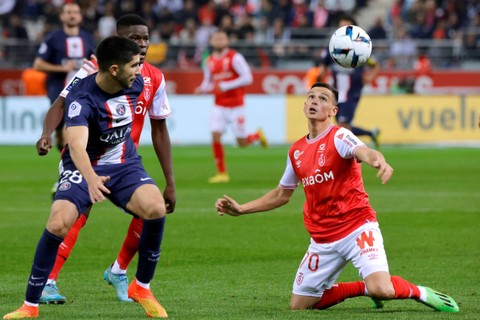 Pemain Paris St Germain Carlos Soler beraksi bersama pemain Stade de Reims' Alexis Flips di Stade Auguste -Delaune, Reims, Prancis, Sabtu (9/10/2022). Foto: Pascal Rossignol/REUTERS