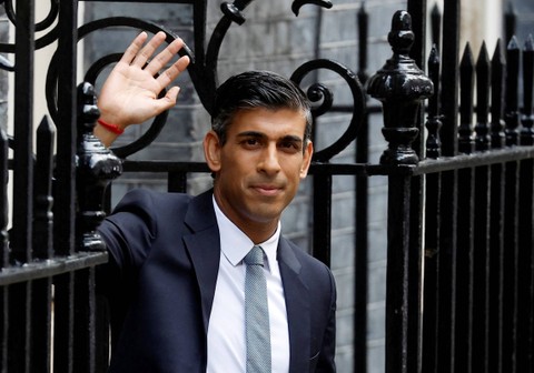 Perdana Menteri Inggris yang baru Rishi Sunak melambai di luar Jalan Downing Nomor 10, di London, Inggris, Selasa (25/10/2022). Foto: Peter Nicholls/REUTERS