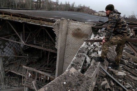 Pavlo, seorang tentara Ukraina, berdiri di atap universitas yang rusak, saat serangan Rusia ke Ukraina berlanjut, dari serangan rudal baru-baru ini di Kramatorsk Ukraina, Selasa (13/12/2022). Foto: Shannon Stapleton/REUTERS