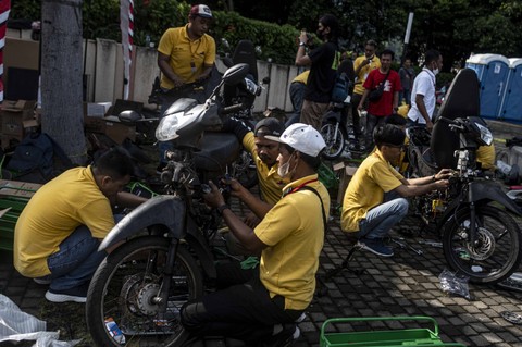 Mekanik menyelesaikan proses konversi motor listrik dalam acara Electric Vehicle (EV) FUNDAY di Plaza Timur Gelora Bung Karno, Jakarta, Minggu (18/12/2022). Foto: Aprillio Akbar/Antara Foto