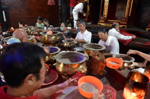 Warga membersihkan perlengkapan ibadah di Vihara Dharmayana, Kuta, Badung, Bali, Minggu (15/1/2023). Foto: Fikri Yusuf/Antara Foto