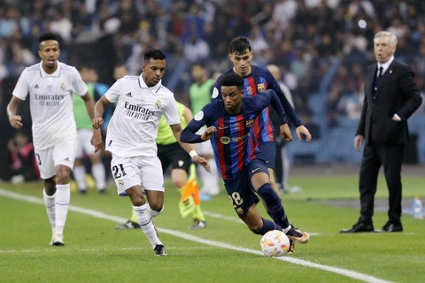 Pemain FC Barcelona Alex Balde berusaha melewati pemain Real Madrid Rodrygo pada pertandingan Piala Piala Super Spanyol di Stadion Internasional King Fahd di Riyadh, Arab Saudi. Foto: Ahmed Yosri/REUTERS