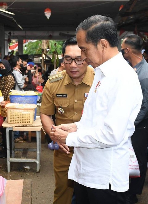 Jokowi (kanan) dan Ridwan Kamil menjajal lato-lato di Pasar Baru Subang. Foto: Kris/Biro Pers Sekretariat Presiden