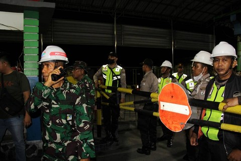 Anggota satuan pengamanan dan prajurit TNI berjaga di pintu masuk Kilang Minyak Putri Tujuh Pertamina RU II Dumai saat terjadi kebakaran akibat ledakan di area "gas compressor" Kilang Dumai, Riau, Sabtu (1/4/2023). Foto: ANTARA FOTO/Aswaddy Hamid