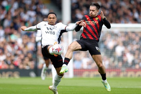 Pemain Manchester City Jack Grealish berebut bola dengan pemain Fulham Kenny Tete pada pertandingan lanjutan Liga Inggris di Stadion Craven Cottage, London, Inggris, Minggu (30/4/2023).  Foto: Peter Cziborra/REUTERS