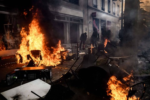 Fasilitas umum yang dibakar saat demonstrasi pada May Day (Hari Buruh) di Lyon, Prancis pada Senin (1/5/2023). Foto: Jeff Pachoud/AFP