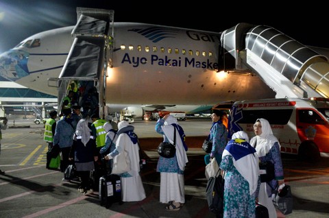 Jemaah calon haji berjalan menaiki pesawat di Bandara Internasional Sultan Hasanuddin Makassar, Kabupaten Maros, Sulawesi Selatan, Rabu (24/5/2023).  Foto: Abriawan Abhe/ANTARA FOTO